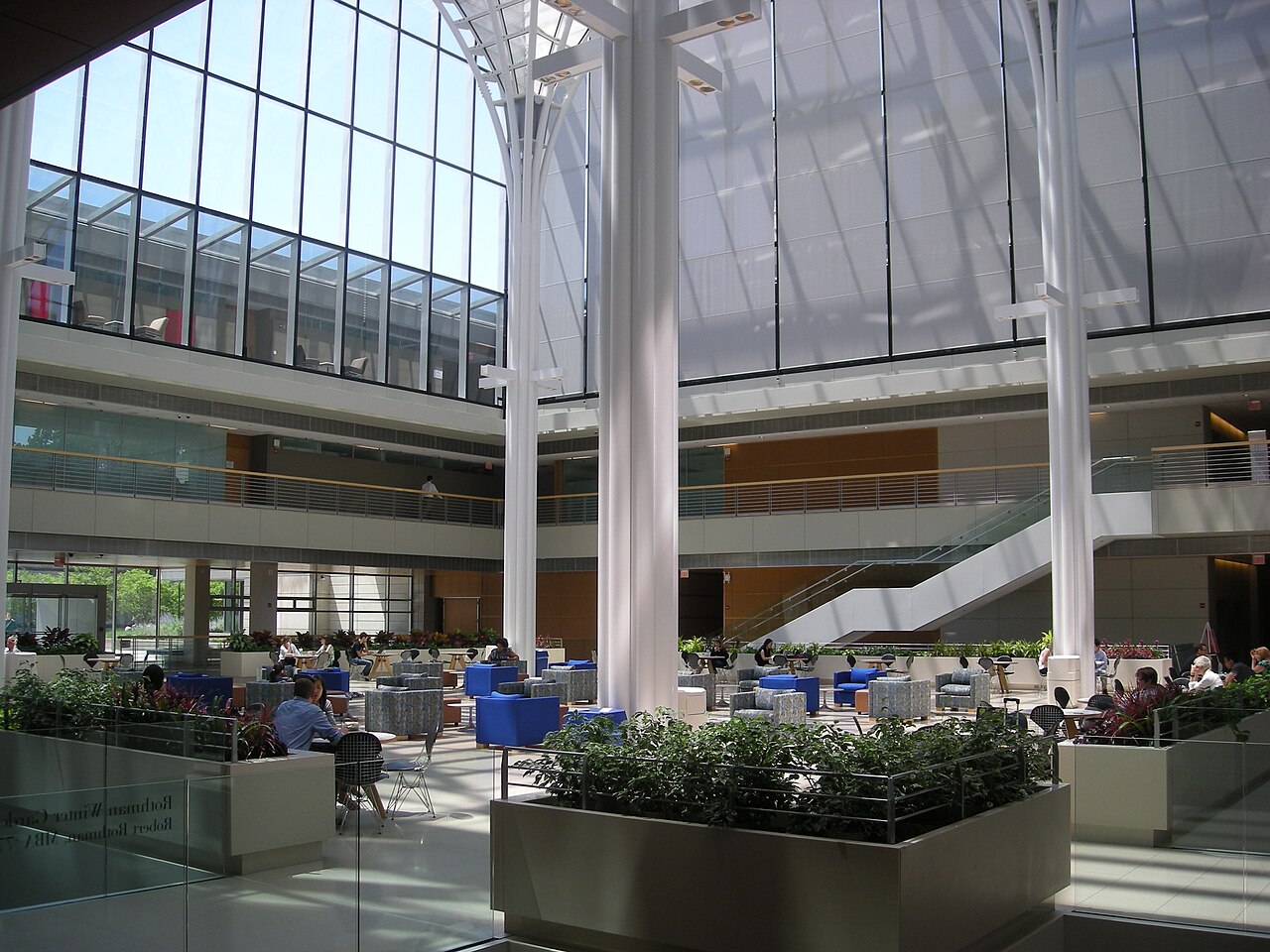 The Winter Garden inside the Harper Center, with students working under the glass roof